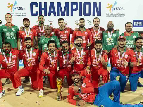 Oman players celebrate with the trophy after winning the first Gulf Cricket Championship last year.