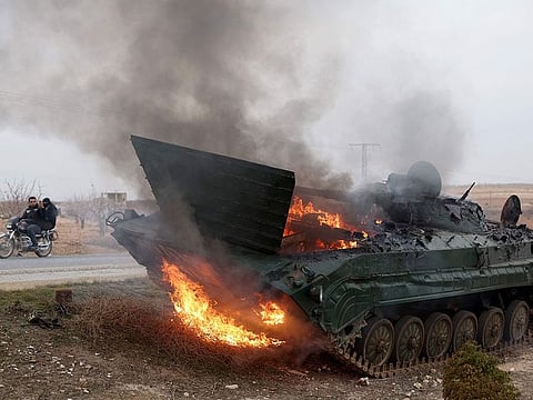 A military vehicle belonging to the Syrian regime forces and seized by anti government forces burn after it was hit by regime forces in the Hama governorate
