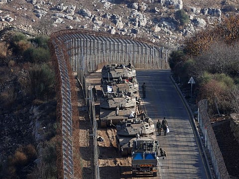 Israeli tanks take position on the border with Syria near the Druze village of Majdal Shams in the Israel-annexed Golan Heights on December 8, 2024.