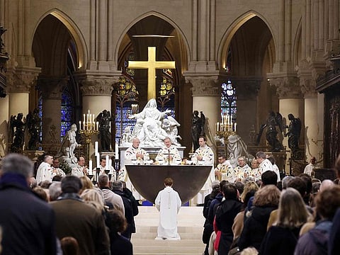 Priest Olivier Ribadeau Dumas (C) celebrates a second mass, open to the public, at the Notre-Dame de Paris cathedral on the day of its re-opening, in Paris.
