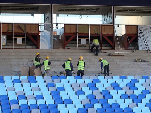 Construction workers are seen at work at the Marrakesh Stadium in the Moroccan capital on December 5.