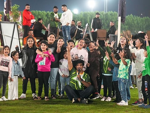 Families including children enjoying the PID's community cricket tournament in Ajman