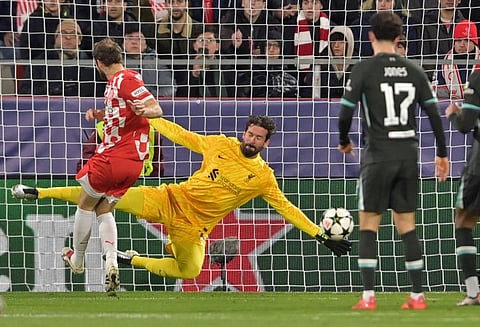 Girona's Dutch defender Daley Blind's shot is stopped by Liverpool's Brazilian goalkeeper Alisson Becker during the Uefa Champions League, league phase football match at the Montilivi stadium in Girona on Tuesday.