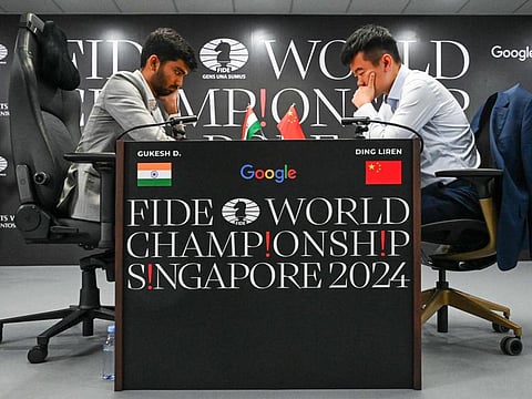 Chinas chess grandmaster Ding Liren (right) and Indias chess grandmaster Gukesh Dommaraju compete during the start of the FIDE World Chess Championship in Singapore.