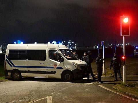 French CRS Police (Republican Security Companies) block off a road near a migrant camp where two security guards and two migrants were shot dead, near Dunkirk, northern France.