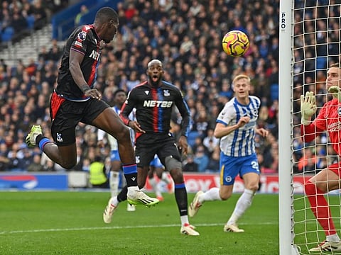 Crystal Palace's Senegalese midfielder Ismaila Sarr (left) heads in their second goal during the English Premier League football match against Brighton and Hove Albion at the American Express Community Stadium in Brighton, southern England on Sunday.