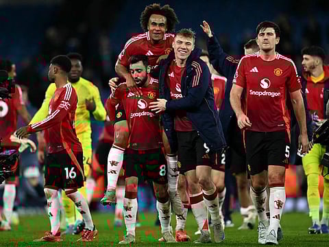 Manchester United's Portuguese midfielder Bruno Fernandes (2L), Dutch striker Joshua Zirkzee (centre) and Danish striker Rasmus Hojlund (2R) celebrate their win against Manchester City in the English Premier League football match at the Etihad Stadium in Manchester, north west England, on Sunday.