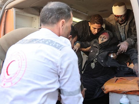 Paramedics put a wounded Palestinian woman into an ambulance before transporting her to the Al Ahli Arab hospital, also known as the Baptist hospital, in Gaza City on December 15, 2024.