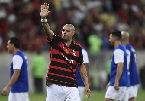 Brazilian former football player Adriano waves to the crowd during his friendly farewell match with legends of Brazil's Flamengo and Italy's Inter Milan at Maracana Stadium in Rio de Janeiro on Sunday.