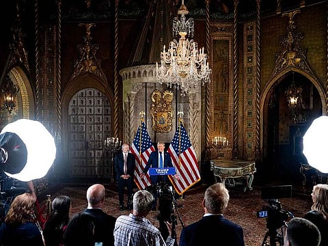 US President-elect Donald Trump, accompanied by Trump's choice for Secretary of Commerce, Cantor Fitzgerald Chairman and CEO Howard Lutnick, speaks at a news conference at Trump's Mar-a-Lago resort on December 16, 2024 in Palm Beach, Florida.