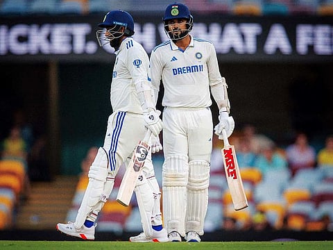 India's Jasprit Bumrah (L) and Akash Deep (R) react after avoiding the follow on, on day four of the third cricket Test match between Australia and India at The Gabba in Brisbane on December 17, 2024.