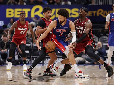 Cade Cunningham Detroit Pistons loses control of the ball between Bam Adebayo and Dru Smith of Miami Heat at Little Caesars Arena on Monday. Detroit won the game 125-124 in overtime.