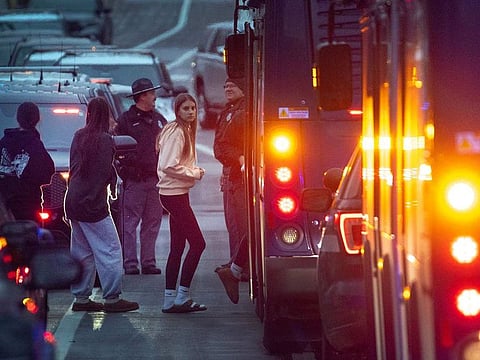 Students are escorted from a church next to the Abundant Life Christian School and loaded on busses to be taken to a reunification center on December 16, 2024 in Madison, Wisconsin.
