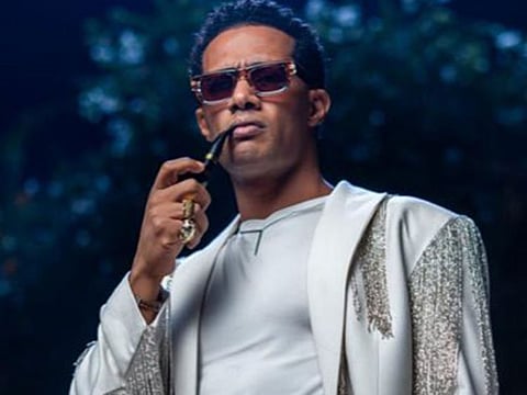 Ramadan appears in a video clip holding Sadat's trademark.