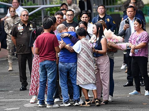 Mary Jane Veloso (C, facing camera) hugs her parents including her children and relatives after arriving at the Correctional Institution for Women in Manila.