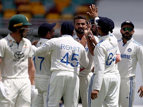 Indias Akash Deep (centre) celebrates with teammates after dismissing Australias Nathan McSweeney (left) on day five of the third Test in Brisbane on Wednesday.