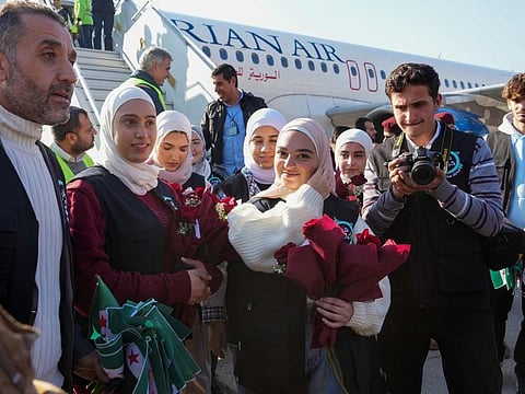 Passengers disembark from a Syrian Air aircraft arriving from Damascus, at the airport of the northern city of Aleppo on December 18, 2024. The first flight since the ouster of Al Assad took off on December 18, from Damascus airport to Aleppo, AFP journalists saw, with thirty-two people including journalists on board.