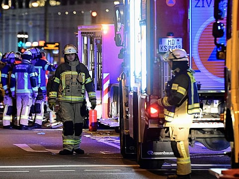 Ambulances and rescuers are seen after a car crashed into a crowd at a Christmas market injuring more than 60 people on December 20, 2024 in Magdeburg, eastern Germany.
