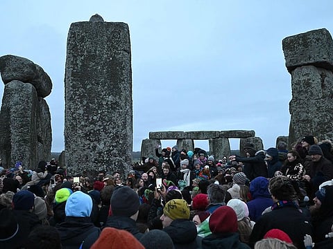 Revellers celebrate the pagan festival of 'Winter Solstice' at Stonehenge in Wiltshire in southern England on December 21, 2024. Followers of Druidism, celebrate the pagan solstice festival at the site each year.