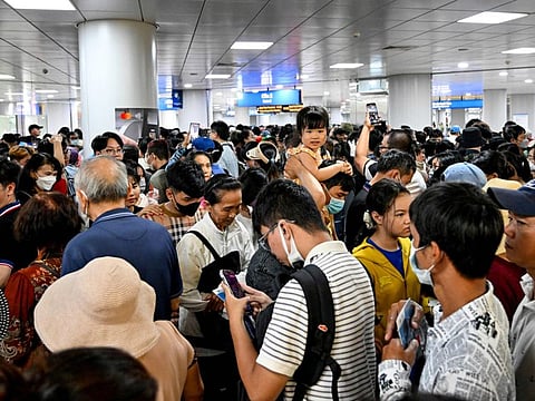 People arrive and leave the plateform at a metro station in Ho Chi Minh City on December 22, 2024. Thousands of selfie-taking Ho Chi Minh City residents crammed into train carriages on December 22, as the traffic-clogged business hub celebrated the opening of its first-ever metro line after years of delays. (Photo by Nhac NGUYEN / AFP)