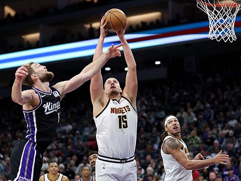 Nikola Jokic of Denver Nuggets and Domantas Sabonis of the Sacramento Kings go for a rebound in the first half on Sunday.