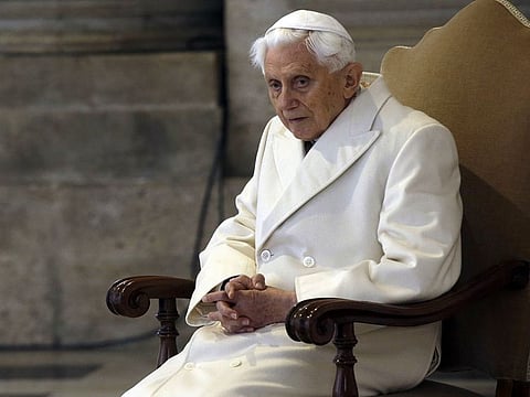 Pope Emeritus Benedict XVI sits in St. Peter's Basilica as he attends the ceremony marking the start of the Holy Year, at the Vatican, Dec. 8, 2015.
