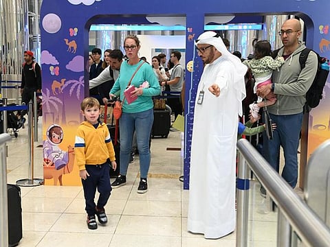 (right) Lieutenant General Mohammed Ahmed Al Marri, director-general of the General Directorate of Residency and Foreigners Affairs in Dubai, interacting with travellers at Dubai International Airport