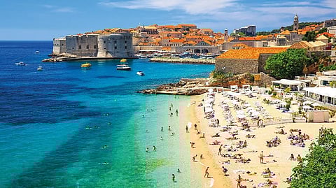 Soak some sun at the beach while taking in the stunning view of the old town