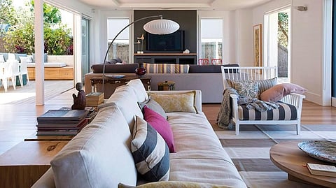 The sofas in the living room are upholstered in outdoor fabric