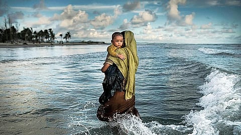 Asad’s photograph of a refugee woman walking towards the shore with her toddler was the first from a Bangladeshi photographer to be featured on the National Geographic cover