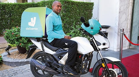 Ngip Yamika Meteran rides around the streets of Dubai on his bike delivering food to customers