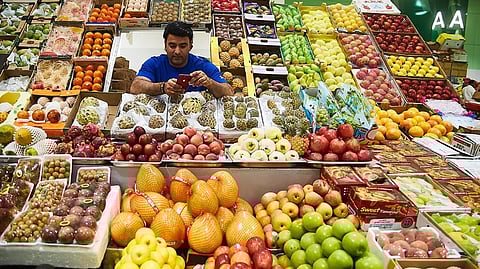 A vendor at his fruit stall