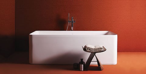A warm shade floor-to-wall colour pop spotlights the newly redesigned Conca solid surface matte bathtub from Ideal Standard