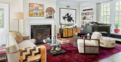 The living room’s eclectic mix of furnishings includes a velvet Donghia sofa and a 1970s Brutalist table by Silas Seandel. Kara Walker’s artwork The Keys to the Coop hangs above the mid-century rosewood burl credenza on the 1920s Chinese Deco rug.