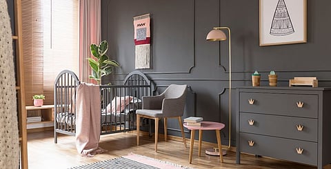 En vogue dark wall colours can work beautifully in a child's room paired with some pastels and light wood furnishings