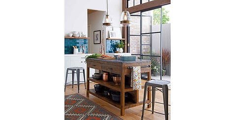 This enviable kitchen space by Crate & Barrel is dominated by its characterful butcher’s block that incorporates useful drawers and shelving.