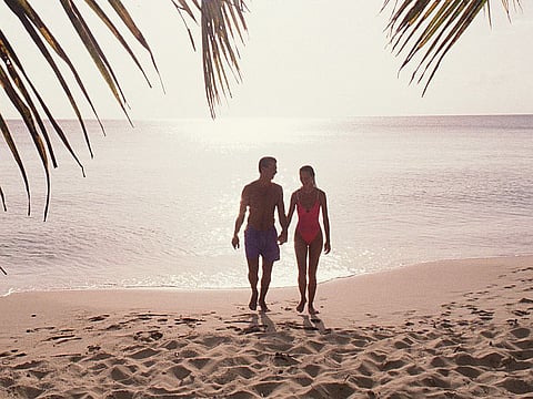 couple on the beach holding hands