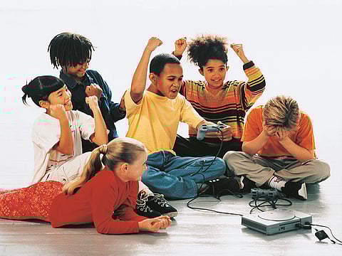 group of kids play computer game