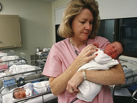 nurse with newborn
