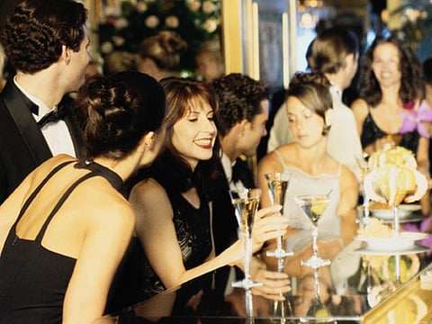 group of people sitting at the bar