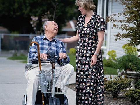 man in wheelchair and caretaker