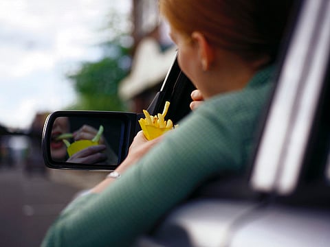 woman driving and eating