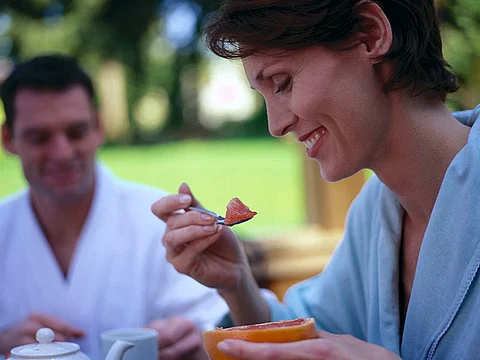 woman eating grapefruit