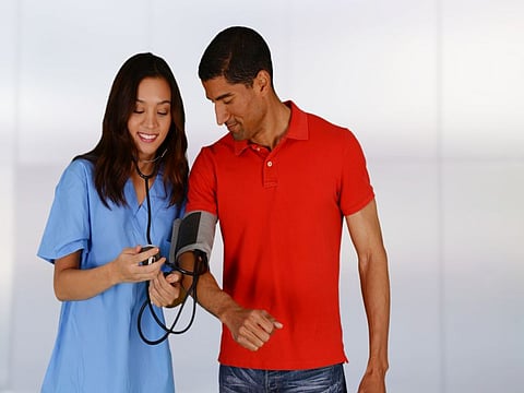hispanic man getting blood pressure checked
