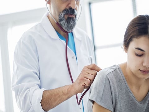 doctor listening to lungs