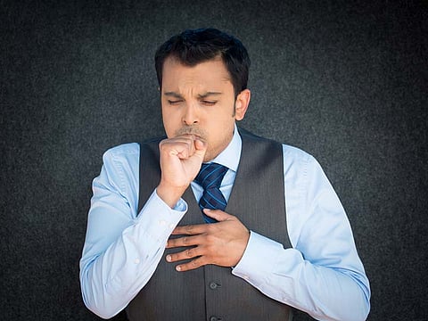 man coughing
