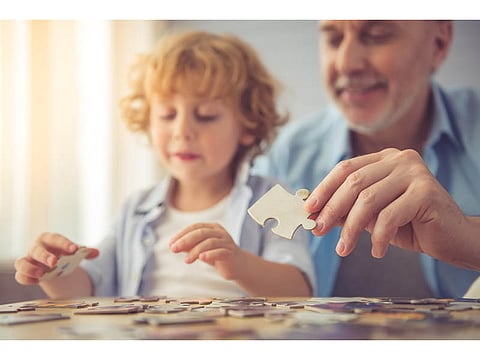 adult playing puzzles with a kid