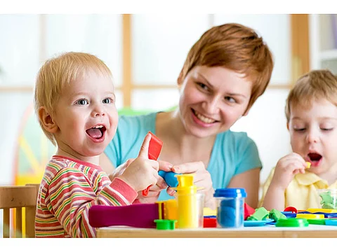 kids playing with play-dough at the table