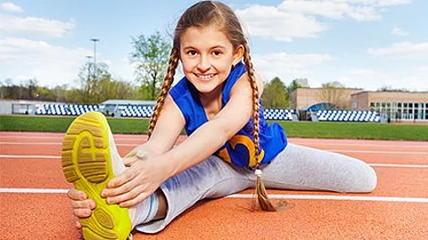 a girl stretching on a track