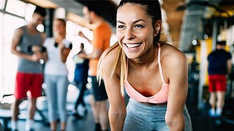 a girl smiling in a gym